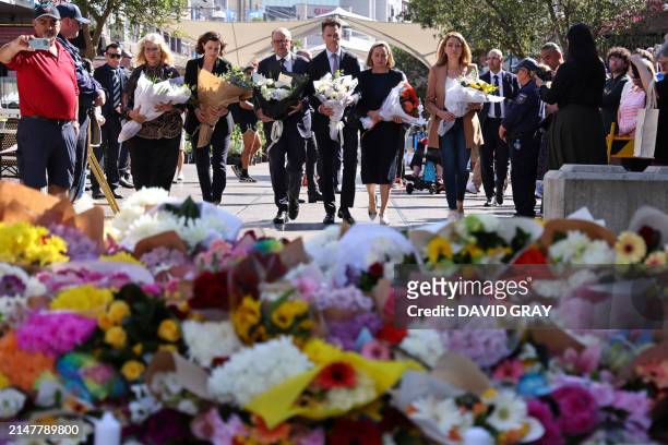 Australian Prime Minister Anthony Albanese walks with New South Wales Premier Chris Minns and other officials as they prepare to leave flowers...