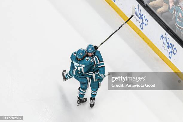 An overhead view of Mario Ferraro celebrating with Fabian Zetterlund of the San Jose Sharks after scoring a goal during the second period of a game...