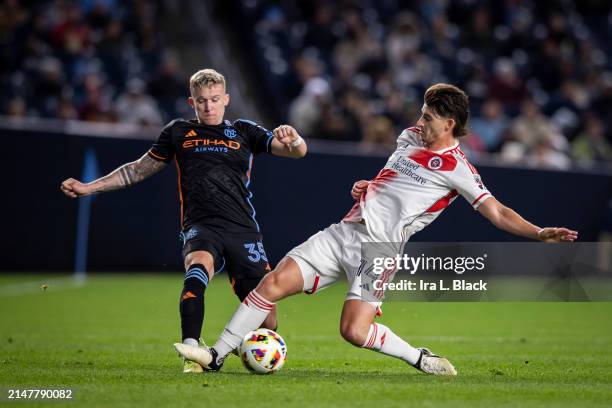 Ian Harkes of New England Revolution commits a penalty on Mitja Ilenic of New York City in the first half of the Major League Soccer match at Yankee...