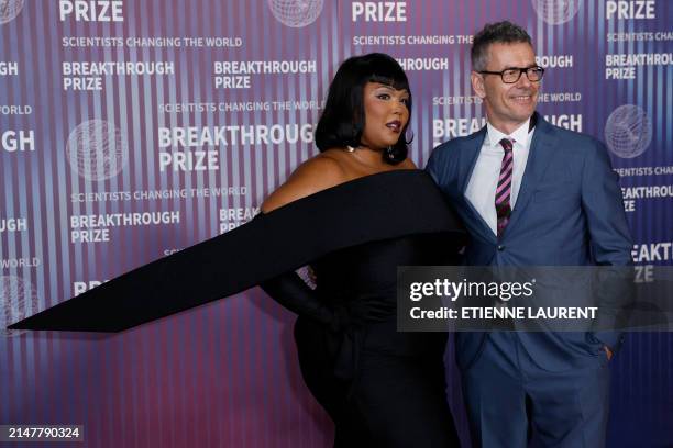 Singer Lizzo and US businessman Robert Kyncl arrive at the Tenth Breakthrough Prize Ceremony at the Academy Museum of Motion Pictures in Los Angeles,...