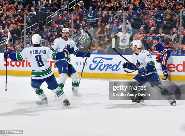 Dakota Joshua of the Vancouver Canucks celebrates his third-period goal against the Edmonton Oilers with teammates Conor Garland and Elias Lindholm...