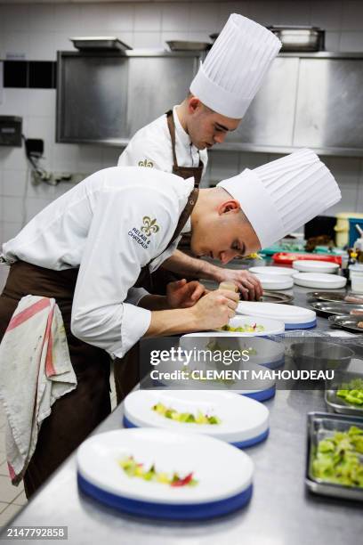 Team of three Michelin-starred French chef for "La Table du Castellet", Fabien Ferre , cook in the kitchen of his restaurant in Le Castellet,...