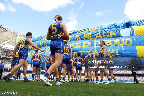 The Eagles prepare to run through the banner during the 2024 AFL Round 05 match between the West Coast Eagles and the Richmond Tigers at Optus...