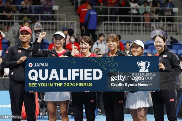 Japan's Naomi Osaka and teammates pose for a photo at Tokyo's Ariake Coliseum on April 13 after they clinched a berth for the Billie Jean King Cup...