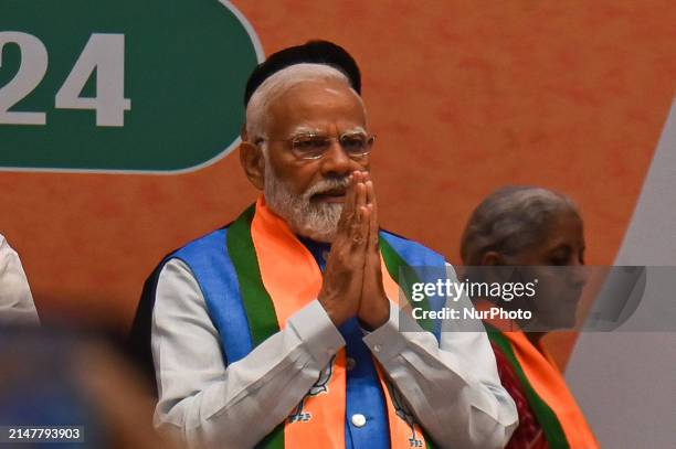 Indian Prime Minister Narendra Modi is gesturing as he arrives for the release of the Bharatiya Janata Party manifesto for the upcoming Indian...