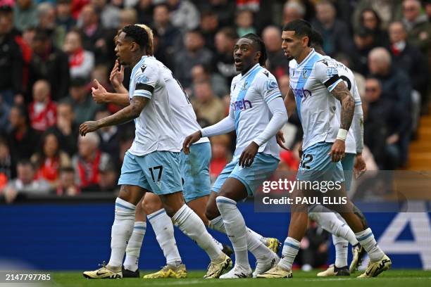 Crystal Palace's English midfielder Eberechi Eze celebrates with teammates after scoring the opening goal during the English Premier League football...