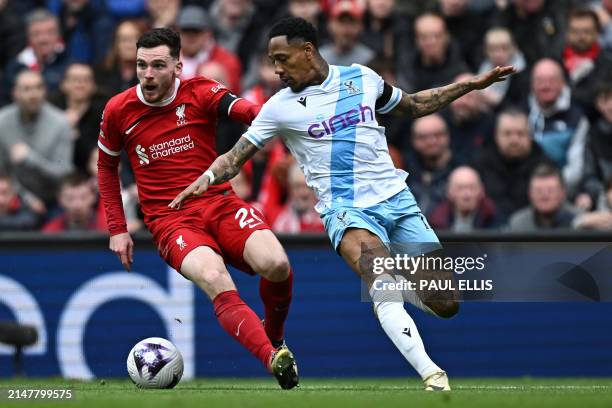 Liverpool's Scottish defender Andrew Robertson vies with Crystal Palace's English defender Nathaniel Clyne during the English Premier League football...