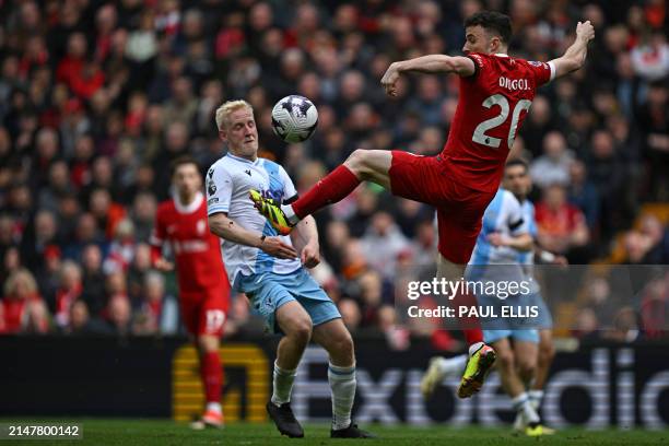 Liverpool's Portuguese striker Diogo Jota vies with Crystal Palace's English midfielder Will Hughes during the English Premier League football match...