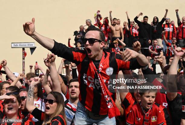 Fans of Bayer Leverkusen celebrate ahead the German first division Bundesliga football match Bayer 04 Leverkusen v Werder Bremen in Leverkusen,...