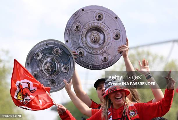 Fans of Bayer Leverkusen celebrate with mock Bundesliga trophies ahead the German first division Bundesliga football match Bayer 04 Leverkusen v...