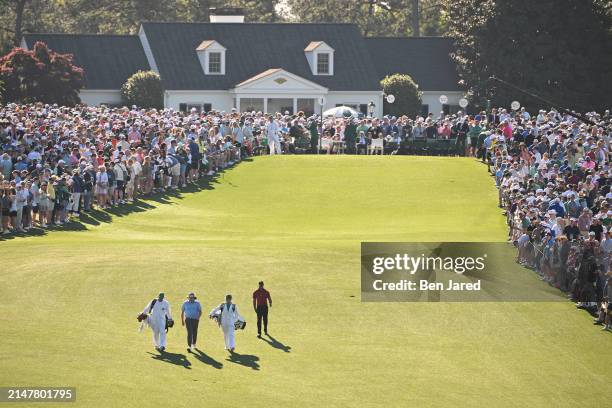 Tiger Woods and amateur Neal Shipley walk down the first tee during the final round of Masters Tournament at Augusta National Golf Club on April 14,...