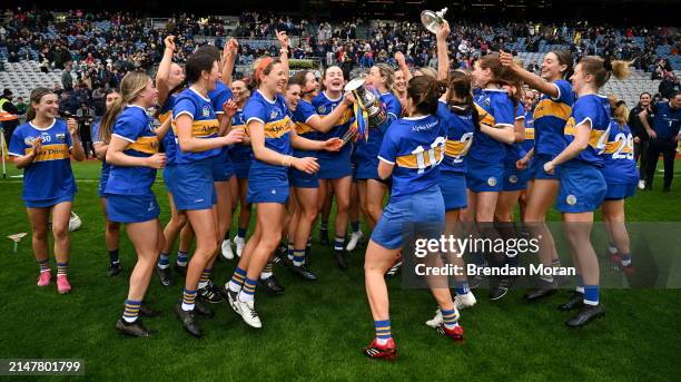 Dublin , Ireland - 14 April 2024; The Tipperary team celebrate with the cup after the Very Camogie League Division 1A Final between Tipperary and...