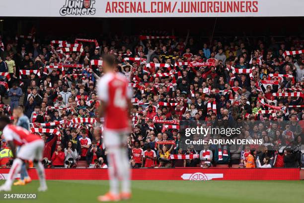 Arsenal fans sing in the crowd ahead of kick-off in the English Premier League football match between Arsenal and Aston VIlla at the Emirates Stadium...