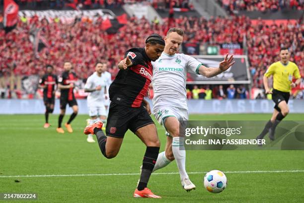 Bayer Leverkusen's French forward Amine Adli and Bremen's German defender Christian Gross vie for the ball during the German first division...