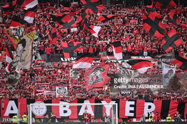 Leverkusen fans wave flags and cheer prior to the German first division Bundesliga football match Bayer 04 Leverkusen v Werder Bremen in Leverkusen,...