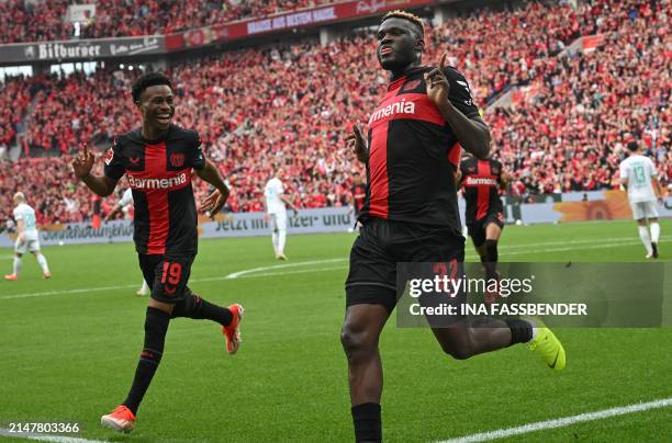 Bayer Leverkusen's Nigerian forward Victor Boniface celebrates scoring the opening goal from the penaty spot with his teammate Bayer Leverkusen's...