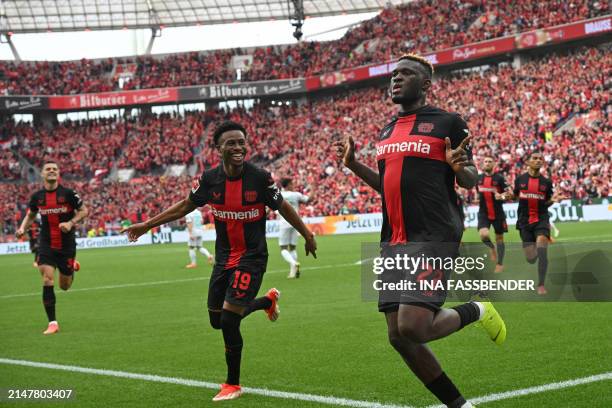 Bayer Leverkusen's Nigerian forward Victor Boniface celebrates scoring the opening goal from the penaty spot with his teammate Bayer Leverkusen's...