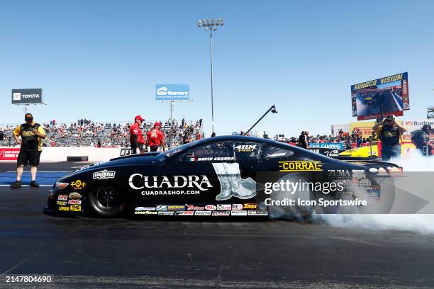 David Cuadra Corral Boots Chevrolet Camaro NHRA Pro Stock does a burnout during the NHRA 4-Wide Nationals Mission Foods Drag Racing Series on April...