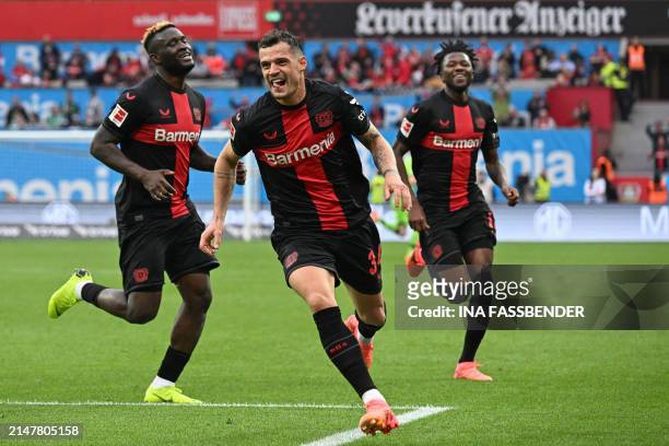 Bayer Leverkusen's Swiss midfielder Granit Xhaka celebrates scoring the 2-0 goal with his team-mates during the German first division Bundesliga...