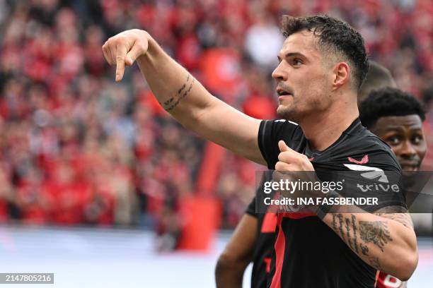 Bayer Leverkusen's Swiss midfielder Granit Xhaka celebrates scoring the 2-0 goal with his team-mates during the German first division Bundesliga...