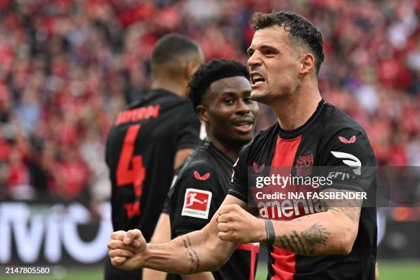Bayer Leverkusen's Swiss midfielder Granit Xhaka celebrates scoring the 2-0 goal with his team-mates during the German first division Bundesliga...