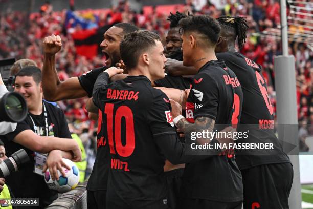 Bayer Leverkusen's Swiss midfielder Granit Xhaka celebrates scoring the 2-0 goal with his team-mates during the German first division Bundesliga...