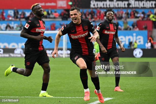 Bayer Leverkusen's Swiss midfielder Granit Xhaka celebrates scoring the 2-0 goal with his team-mates during the German first division Bundesliga...