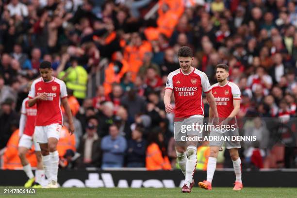 Arsenal's English midfielder Declan Rice and teammates react to going two goals behind during the English Premier League football match between...