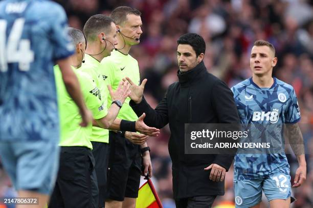 Arsenal's Spanish manager Mikel Arteta shakes hands with the officials after the English Premier League football match between Arsenal and Aston...