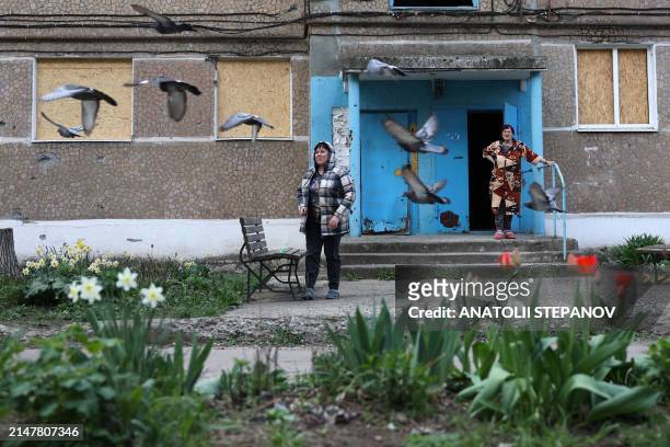 Women are seen near their shell-damaged house in in the town of Kurakhove, Donetsk region, on April 14 amid the Russian invassion in Ukraine.