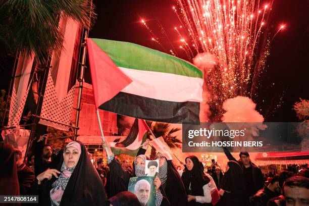 Iranian pro-government supporters shout anti-Israel slogans while waving the Palestine flag at Palestine Square in Tehran, on April 14 in a...