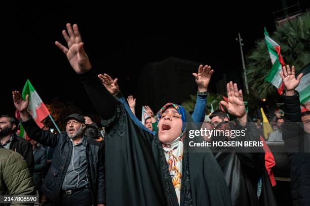 Iranian pro-government supporters shout anti-Israel slogans at Palestine Square in Tehran, on April 14 in a celebration of the early morning Iran's...