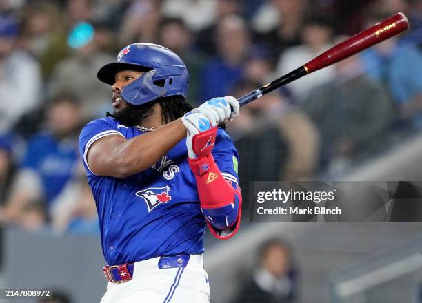 Vladimir Guerrero Jr. #27 of the Toronto Blue Jays hits an RBI single against the Colorado Rockies during the third inning in their MLB game at the...