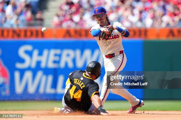 Bryson Stott of the Philadelphia Phillies attempts to turn a double play against Rowdy Tellez of the Pittsburgh Pirates in the top of the fourth...