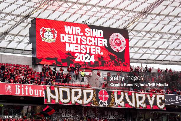 The scoreboard shows that Bayer 04 Leverkusen are German champions and reads wir sind Deutsche Meister 2024 after the Bundesliga match between Bayer...