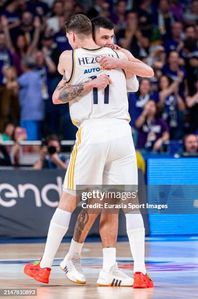 Gabriel Deck of Real Madrid hugs Mario Hezonja of Real Madrid during ACB Liga Endesa Basketball match between Real Madrid and Joventut Badalona at...