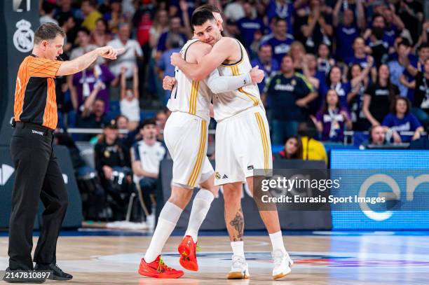 Gabriel Deck of Real Madrid hugs Mario Hezonja of Real Madrid during ACB Liga Endesa Basketball match between Real Madrid and Joventut Badalona at...