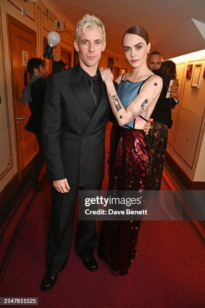 Luke Treadaway and Cara Delevingne pose backstage during The Olivier Awards 2024 at Royal Albert Hall on April 14, 2024 in London, England.