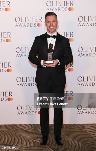 Adam Fisher, winner of the Best Sound Design award for "Sunset Boulevard", poses in the winners room at The Olivier Awards 2024 at Royal Albert Hall...