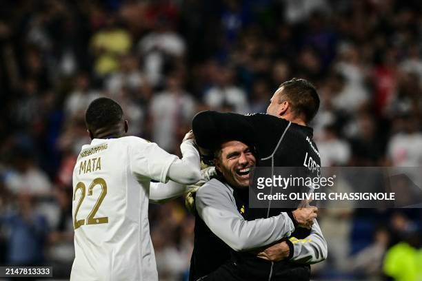 Lyon's goalkeepers' coach Remy Vercoutre celebrates with Lyon's Portuguese goalkeeper Anthony Lopes during the French L1 football match beetween...