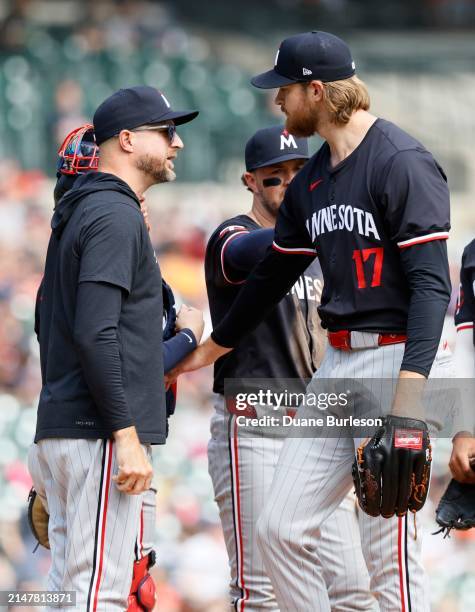 Manager Rocco Baldelli of the Minnesota Twins talks with starting pitcher Bailey Ober as he is being pulled during the seventh inning of a game...