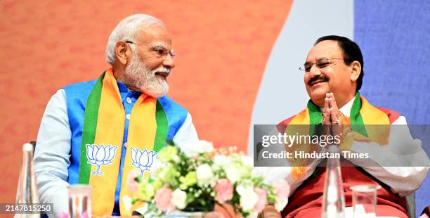 Prime Minister Narendra Modi with BJP Natinoal President JP Nadda during the launch of BJP's Sankalp Patra for Lok Sabha Elections 2024 at BJP HQ, on...