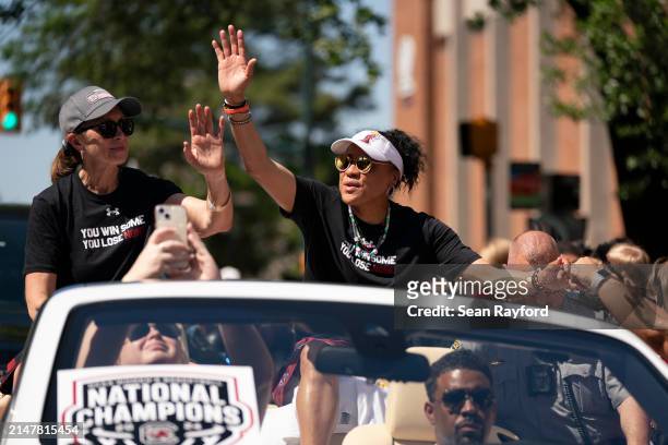 South Carolina coach Dawn Staley, right, and Lisa Boyer wave to fans during a NCAA Women's Basketball Championship parade on April 14, 2024 in...