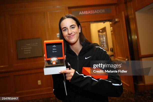 Caitlin Clark poses for a photos as she receives a gift from Tissot at the player hotel during the 2024 WNBA Draft on April 14, 2024 in New York, New...