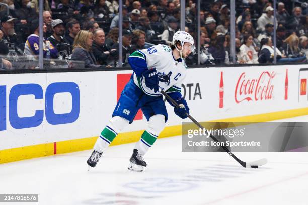 Vancouver Canucks defenseman Quinn Hughes skates with the puck during the Vancouver Canucks game versus the Los Angeles Kings on April 6 at...