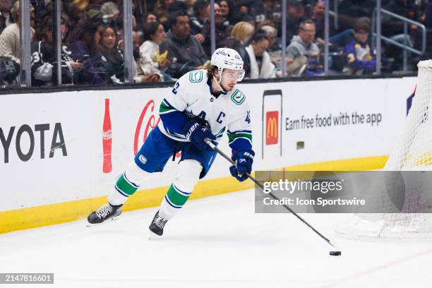 Vancouver Canucks defenseman Quinn Hughes skates with the puck during the Vancouver Canucks game versus the Los Angeles Kings on April 6 at...