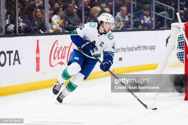 Vancouver Canucks defenseman Quinn Hughes skates with the puck during the Vancouver Canucks game versus the Los Angeles Kings on April 6 at...