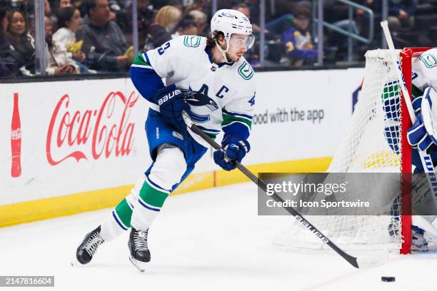 Vancouver Canucks defenseman Quinn Hughes skates with the puck during the Vancouver Canucks game versus the Los Angeles Kings on April 6 at...