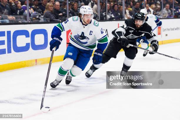 Vancouver Canucks defenseman Quinn Hughes skates with the puck during the Vancouver Canucks game versus the Los Angeles Kings on April 6 at...