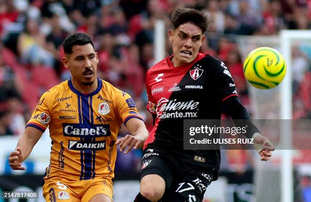 Atlas' Jose Lozano fights for the ball with San Luis' Ricardo Chavez during their Mexican Clausura tournament football match at the Jalisco stadium...